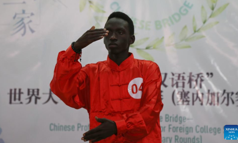 A contestant participates in the 21st Chinese Bridge Chinese proficiency competition for Senegalese college students at the Confucius Institute at Cheikh Anta Diop University of Dakar (UCAD) in Dakar, Senegal, June 8, 2022. Ten students participated in the contest organized by the Chinese Embassy in Senegal and the Confucius Institute at UCAD. Under the theme of One World One Family, the final consisted of three parts: keynote speech, knowledge quiz and talent show. Photo: Xinhua