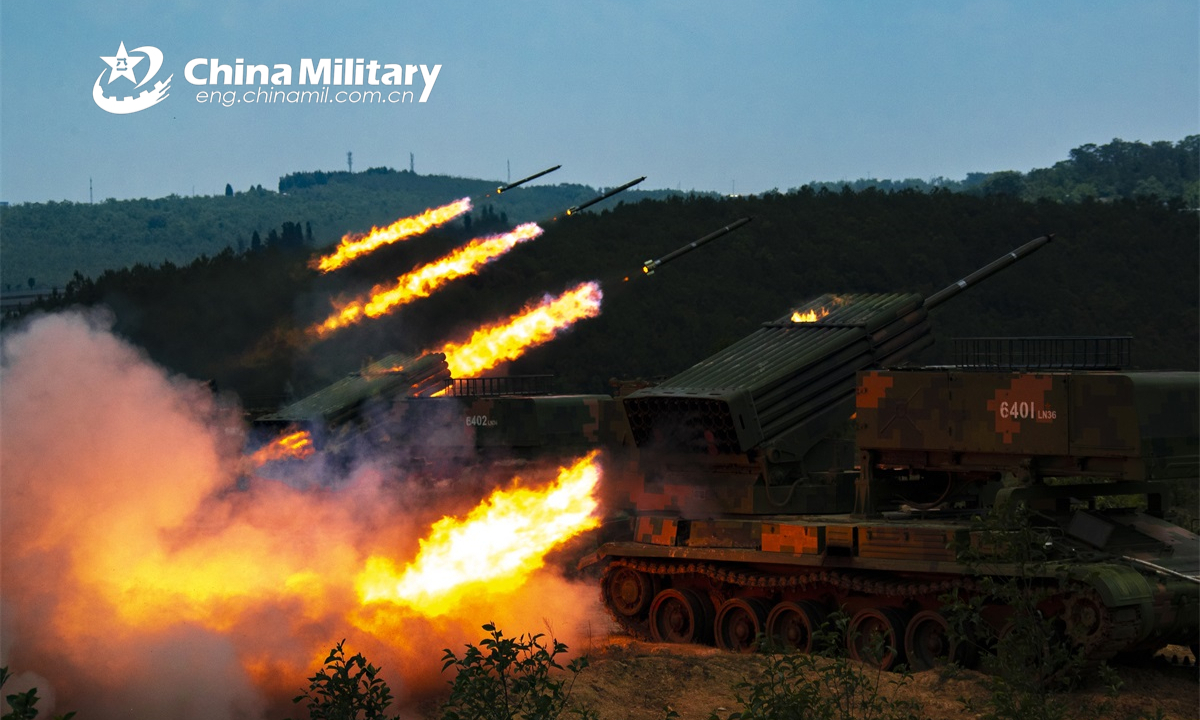 Armored vehicles attached to a combined-arms brigade under the PLA 75th Group Army fire rockets at the mock targets during a live-fire training exercise on May 19, 2022. (eng.chinamil.com.cn/Photo by Tang Zhoutao)