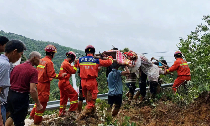 A woman is rescued on June 9, 2022, after landslides hit Beiliu, Guangxi Zhuang Autonomous Region. Photo: VCG