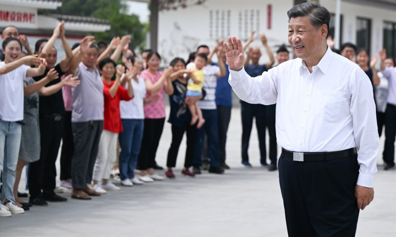 Chinese President Xi Jinping, also general secretary of the Communist Party of China Central Committee and chairman of the Central Military Commission, waves to villagers while visiting the village of Yongfeng to learn about local efforts in advancing high-standard farmland development, boosting grain production, promoting rural revitalization, maintaining effective COVID-19 prevention and control, in Meishan, Southwest China's Sichuan Province, June 8, 2022. Photo: Xinhua/Xie Huanchi