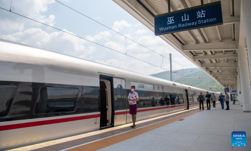 A bullet train stops at the Wushan Railway Station in Wushan County, southwest China's Chongqing Municipality, June 14, 2022, during a trial operation of the Chongqing-Wushan section of the high-speed railway linking Chongqing and Zhengzhou, capital of central China's Henan Province. The Zhengzhou-Chongqing High-speed Railway will be fully operational in late June, cutting the travel time between the two cities from 8 hours to 4 hours and upgrading the high-speed railway network in central China and southwest China. (Xinhua/Tang Yi)