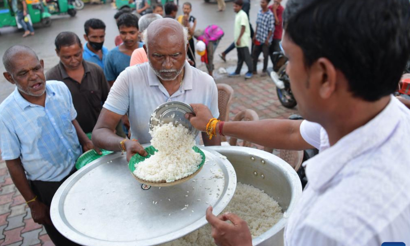 People get food from a social worker during the World Food Safety Day in Agartala, the capital city of India's northeastern state of Tripura, June 7, 2022. Photo: Xinhua