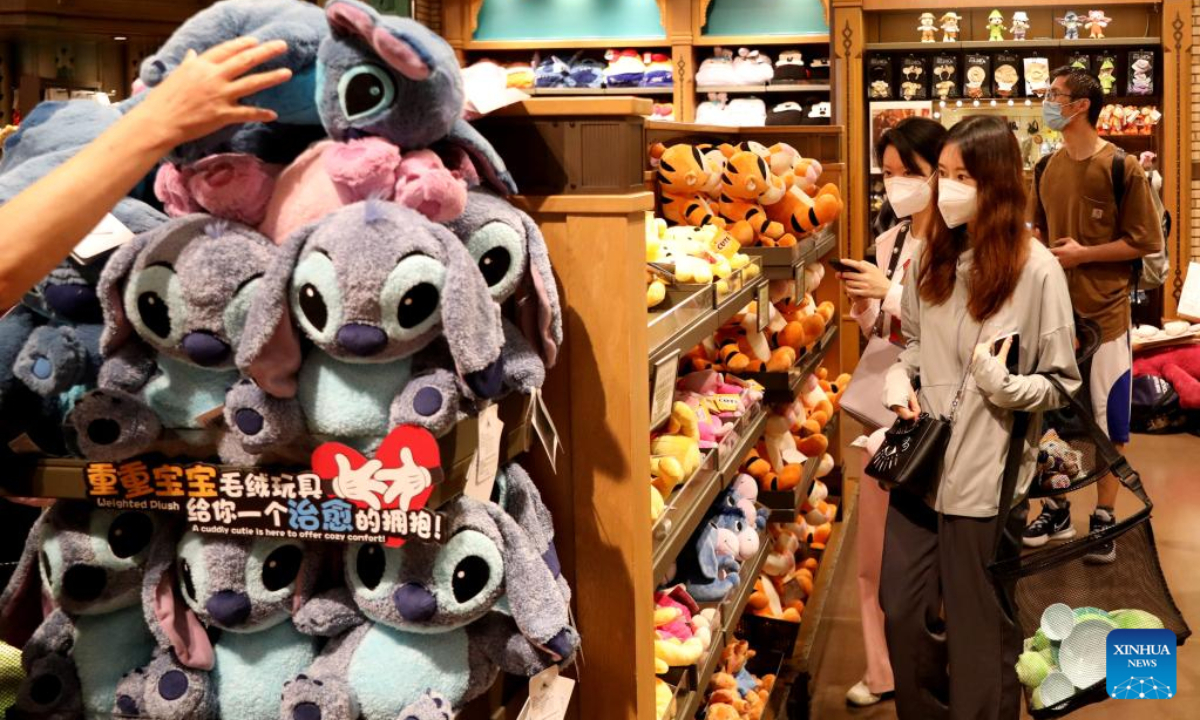 Tourists purchase toys at the World of Disney Store in Shanghai, east China on June 10, 2022. Shanghai Disney Resort partially resumed operations on Friday as the COVID-19 epidemic wanes in the city. Wishing Star Park, the World of Disney Store and Blue Sky Boulevard resumed operations first and Shanghai Disneyland would remain temporarily closed until further notice. Photo:Xinhua