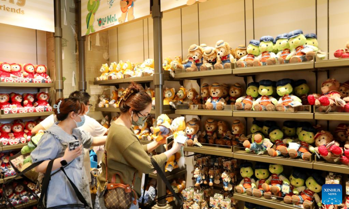 Tourists purchase toys at the World of Disney Store in Shanghai, east China on June 10, 2022. Shanghai Disney Resort partially resumed operations on Friday as the COVID-19 epidemic wanes in the city. Wishing Star Park, the World of Disney Store and Blue Sky Boulevard resumed operations first and Shanghai Disneyland would remain temporarily closed until further notice. Photo:Xinhua