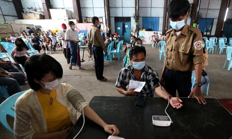 People check blood pressure before receiving a dose of COVID-19 vaccine in Yangon, Myanmar, June 6, 2022. Myanmar has fully vaccinated more than 26.8 million people against COVID-19 as of Saturday, according to the Ministry of Health on Sunday.(Photo: Xinhua)