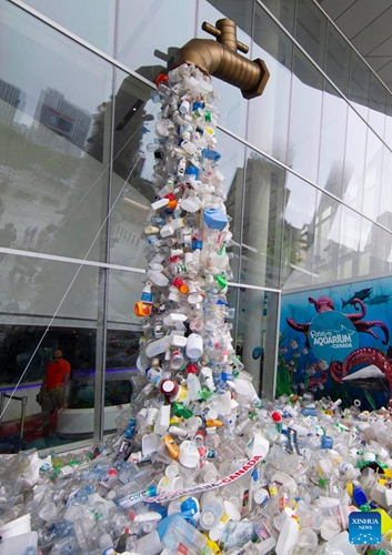 The art installation Turn Off The Plastic Tap is seen outside the Ripley's Aquarium of Canada in Toronto, Canada, on June 7, 2022. The art installation Turn Off The Plastic Tap is on display here to raise awareness of the plastic pollution problem.(Photo: Xinhua)