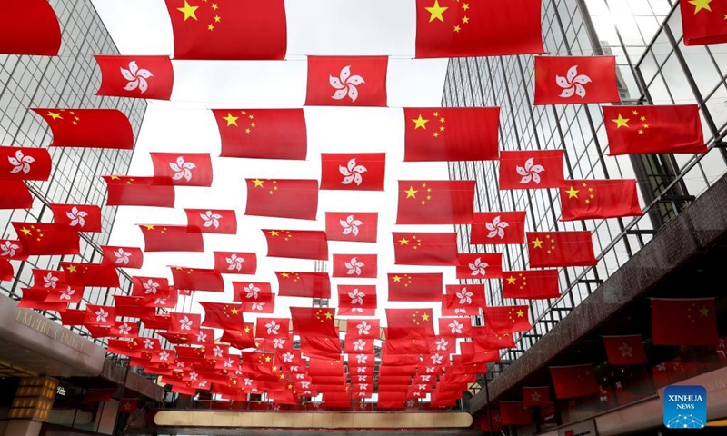 China's national flags and the Hong Kong Special Administrative Region (HKSAR) flags are hung above a street in Hong Kong, south China, June 20, 2022. This year marks the 25th anniversary of Hong Kong's return to the motherland.(Photo: Xinhua)