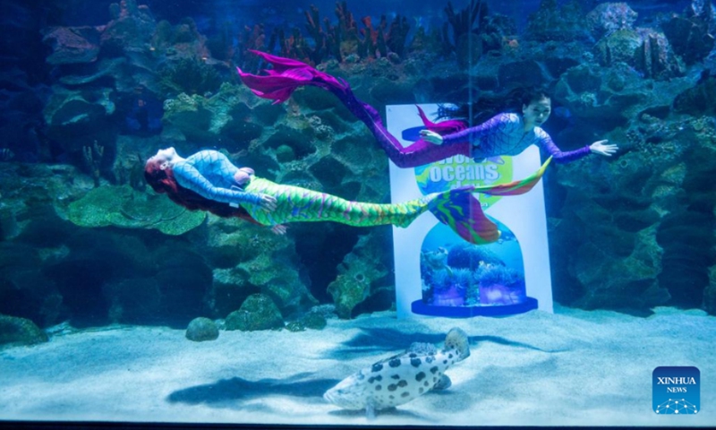 Divers perform during an underwater mermaid show on the occasion of World Oceans Day at Aquaria KLCC in Kuala Lumpur, Malaysia, June 8, 2022. Malaysia's biggest oceanarium Aquaria KLCC marked World Oceans Day on Wednesday with a ceremony here to remind the public of the impact of human actions on the ocean and raise awareness of the importance of sustainable marine management.(Photo: Xinhua)