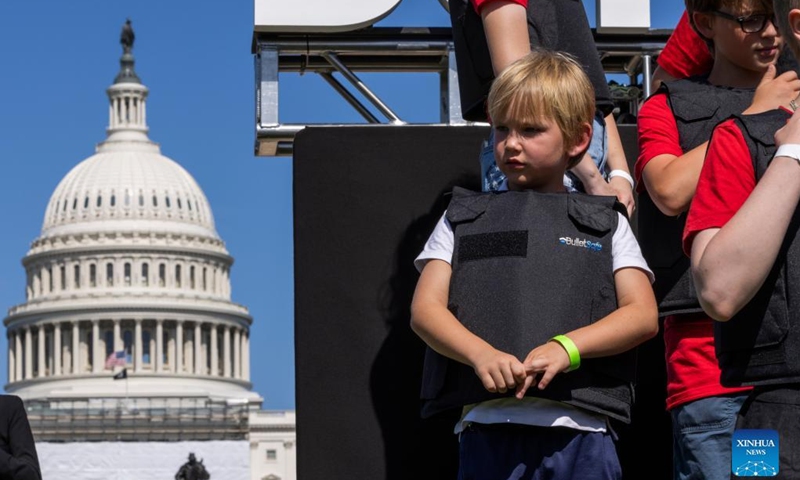 Students wearing bulletproof vests hold a rally near the Capitol Reflecting Pool in Washington, D.C., the United States, June. 6, 2022. A group of student activists gathered in Washington, D.C. on Monday afternoon, calling for actions from U.S. politicians in the wake of mass shootings over the past few weeks.(Photo: Xinhua)