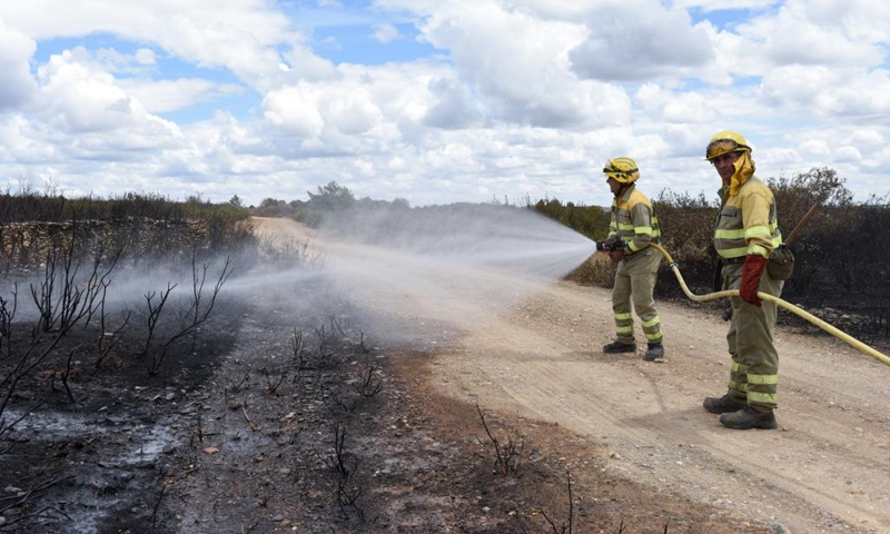 Forest firefighters work at a hot area in the province of Zamora, Spain, on June 20, 2022. A wildfire caused by a lightning strike on June 15 in the province of Zamora has become the worst ever recorded in the history of Spain, regional authorities confirmed on June 20.(Photo: Xinhua)