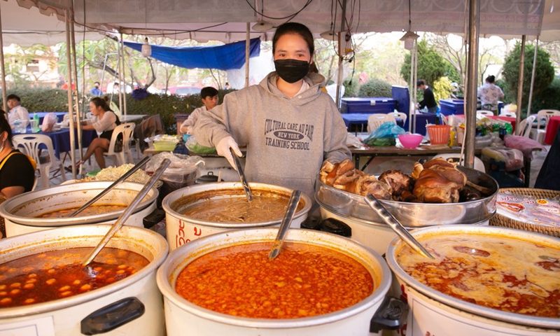 A vendor sells food during Lao Food Festival 2022 in Vientiane, Laos, on Jan. 26, 2022.(Photo: Xinhua)
