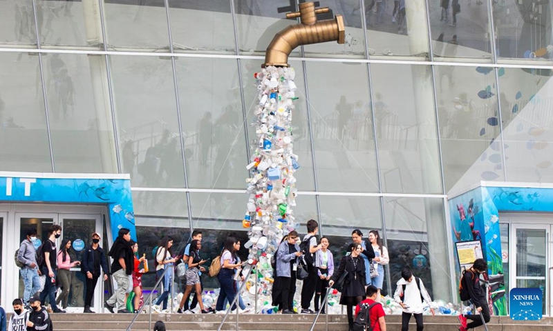 People walk past the art installation Turn Off The Plastic Tap outside the Ripley's Aquarium of Canada in Toronto, Canada, on June 7, 2022. The art installation Turn Off The Plastic Tap is on display here to raise awareness of the plastic pollution problem.(Photo: Xinhua)