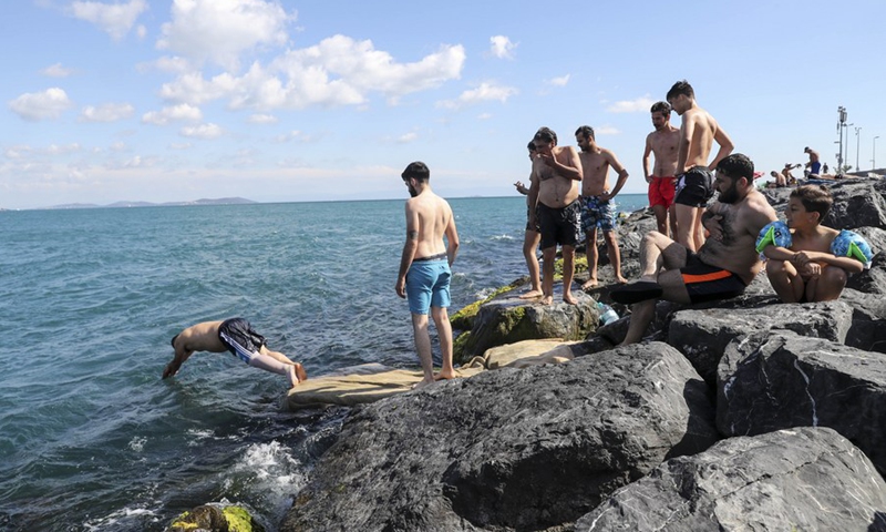 People swim in the Bosphorus Strait in Istanbul, Turkey on June 18, 2022.(Photo: Xinhua)