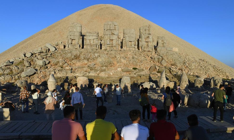 People visit the tomb-sanctuary on Mount Nemrut in Adiyaman Province, Turkey, on June 7, 2022. Mount Nemrut (Nemrut Dag) was inscribed on UNESCO World Heritage List in 1987. On Mount Nemrut, the mausoleum of Antiochus I, who reigned over Commagene, a kingdom founded north of Syria and the Euphrates after the breakup of Alexander's empire, is one of the most ambitious constructions of the Hellenistic period.(Photo: Xinhua)