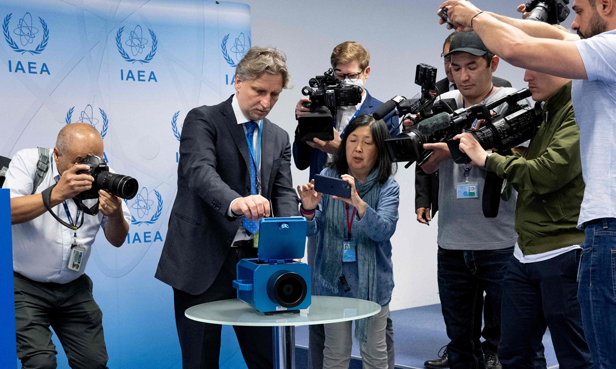 People film a demonstration of a monitoring camera used in Iran during a press conference of Rafael Grossi, director general of the International Atomic Energy Agency (IAEA), in Vienna, Austria on June 09, 2022. Iran is removing 27 surveillance cameras at nuclear facilities, said the IAEA head, after the IAEA's board censured Tehran over what the agency calls Iran's failure to provide 