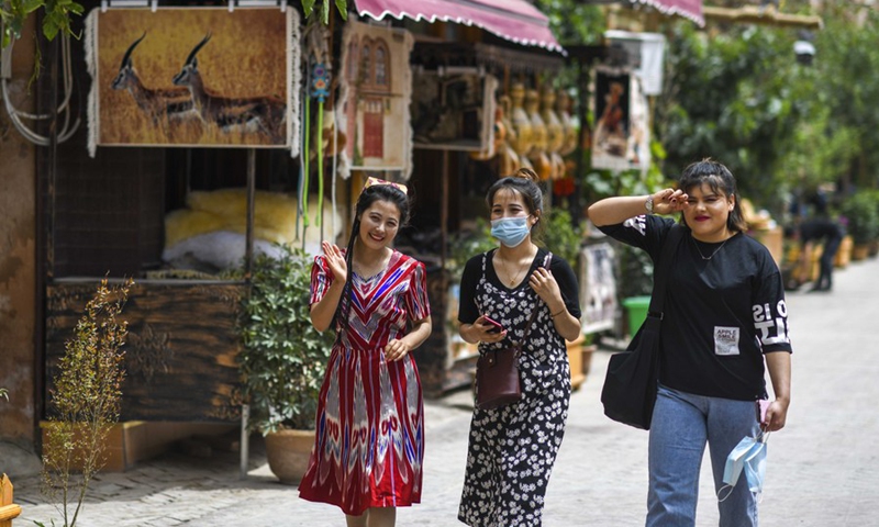 Local residents walk in a street at a scenic spot in the ancient city of Kashgar, northwest China's Xinjiang Uygur Autonomous Region, May 16, 2020. Photo: Xinhua