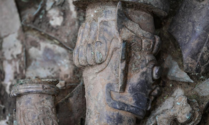 Photo taken on June 1, 2022 shows part of a bronze sculpture with a human head and snake body excavated from the No.8 sacrificial pit at Sanxingdui Ruins site in southwest China's Sichuan Province. Archaeologists have recently made some stunning discoveries at the famed Sanxingdui Ruins site in southwest China's Sichuan Province.