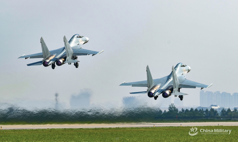 Two fighter jets attached to an aviation brigade of the air force under the PLA Eastern Theater Command take off from a military base in formation for a flight training exercise on May 14, 2022.Photo:Xinhua