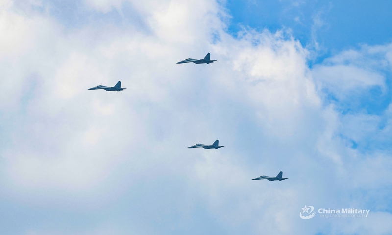 Four fighter jets attached to an aviation brigade of the air force under the PLA Eastern Theater Command soar in the sky in V-formation during a flight training exercise on May 14, 2022.Photo:Xinhua