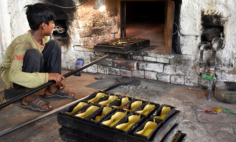A boy works in a bakery on World Day Against Child Labor in Lahore, Pakistan on June 12, 2022.Photo:Xinhua