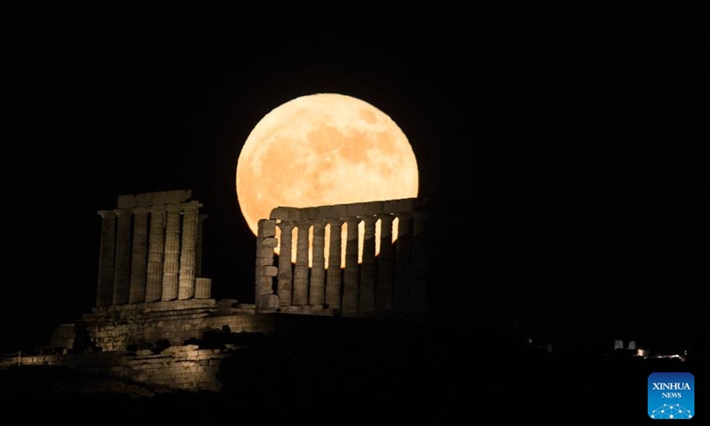 A full moon is seen over the Temple of Poseidon at cape Sounion, some 70 km southeast of Athens, Greece, on June 14, 2022.(Photo: Xinhua)