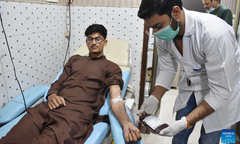 A man donates blood at a blood center on World Blood Donor Day in Lahore, Pakistan, on June 14, 2022. World Blood Donor Day is marked on June 14 each year.(Photo: Xinhua)