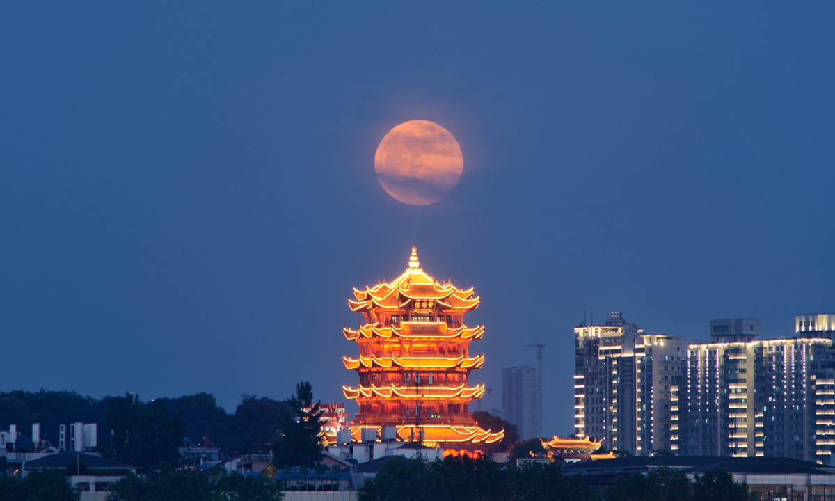 The Strawberry Supermoon rises behind the Yellow Crane Tower, or Huanghelou, a landmark of the city of Wuhan, Central China's Hubei Province, on June 14, 2022, as it is also observed around the world the day when it's at the closest distance to Earth in its orbit. Photo: VCG