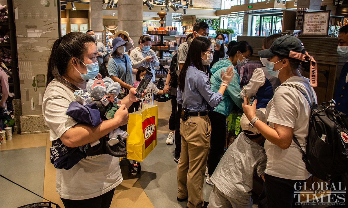 Consumers buy Disney souvenirs at the World of Disney Store in Shanghai Disney Resort on June 16. Photo: Wu Shiliu
