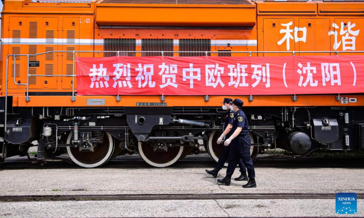 Customs officers pass a China-Europe freight train at the Shenyang East Railway Station in Shenyang, northeast China's Liaoning Province, June 16, 2022. Photo:Xinhua