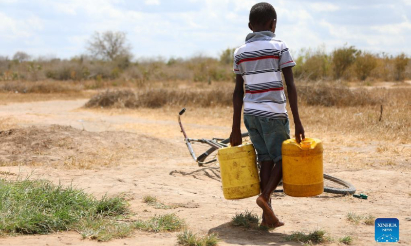 A boy carries buckets of water in Kidemu sub-location in Kilifi County, Kenya, March 23, 2022. The Horn of Africa drought has thrust at least 18.4 million people, including more than 7.1 million acutely malnourished children, into severe food insecurity, UN humanitarians said on Monday. Most drought victims are in Ethiopia, Kenya and Somalia. (Xinhua/Dong Jianghui)