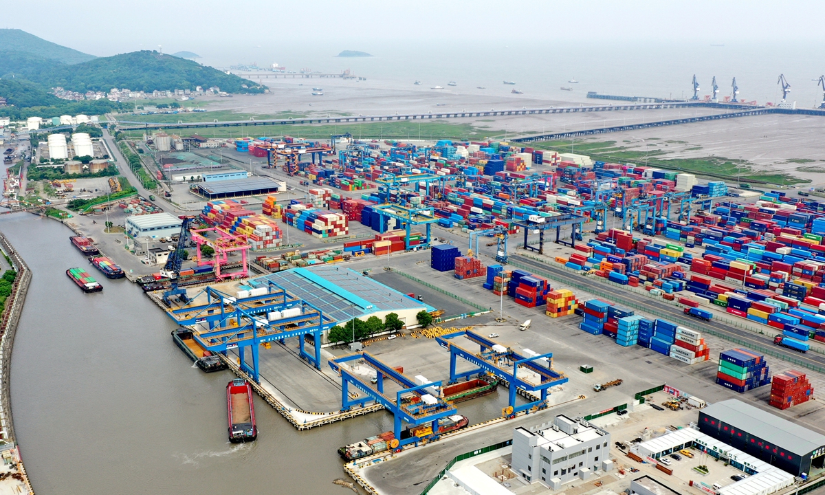 Containers are loaded on barges at a port in Jiaxing, East China's Zhejiang Province on June 16, 2022. The throughput of containers that were shipped between oceangoing vessels and river-going vessels saw a sharp increase of 69.4 percent year-on-year during the first five months of 2022, according to Ningbo Zhoushan Port Group. Photo: Courtesy of Ningbo Zhoushan Port Group