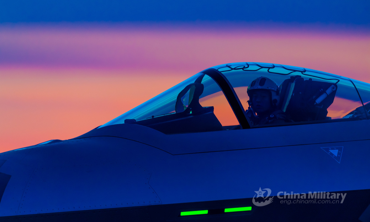 A J-20 fighter jet pilot assigned to a PLA air force base contacts with the control tower in the cockpit after landing safely on the runway during an air combat training exercise involving multi-type fighter jets on May 17, 2022. (eng.chinamil.com.cn/Photo by Yang Jun)