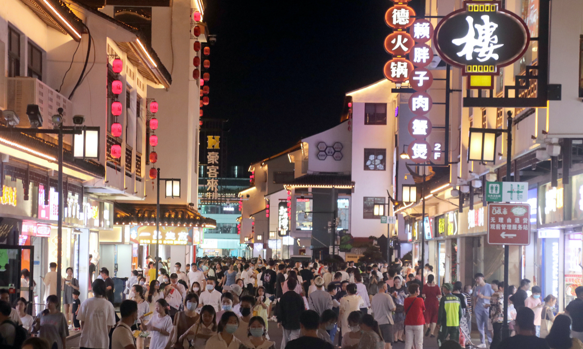 People walk and shop at Guanqian Street in Suzhou, East China's Jiangsu Province on June 20, 2022. Photo: VCG
