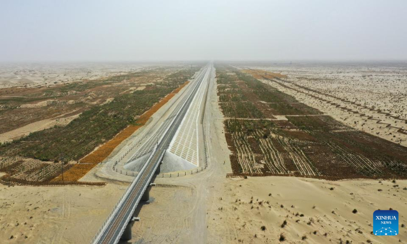 Aerial photo taken on May 19, 2022 shows the windbreaks including grass grids, shrubs and trees along the Hotan-Ruoqiang Railway in northwest China's Xinjiang Uygur Autonomous Region. (Xinhua/Ding Lei)