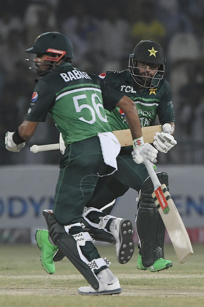 Pakistan's captain Babar Azam (left) and teammate Imam-ul-Haq run between the wickets during the first one-day international cricket match between Pakistan and West Indies in Multan, Pakistan on June 8, 2022. Photo: AFP