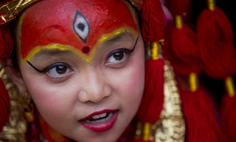 A girl dressed up as a living goddess participates in the celebration of the traditional Kumari Puja in Kathmandu, Nepal, June 18, 2022.Photo:Xinhua