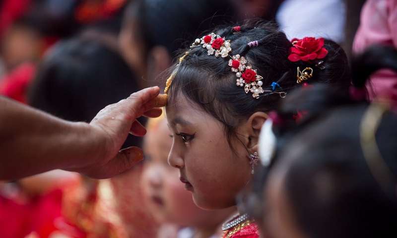 A girl dressed up as a living goddess participates in the celebration of the traditional Kumari Puja in Kathmandu, Nepal, June 18, 2022.Photo:Xinhua