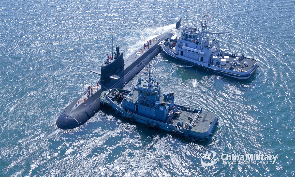 Two towboats attached to a submarine flotilla with the navy under the PLA Northern Theater Command jointly tow a submarine to bear off a port for the maritime combat training drills in late May, 2022.Photo:China Military