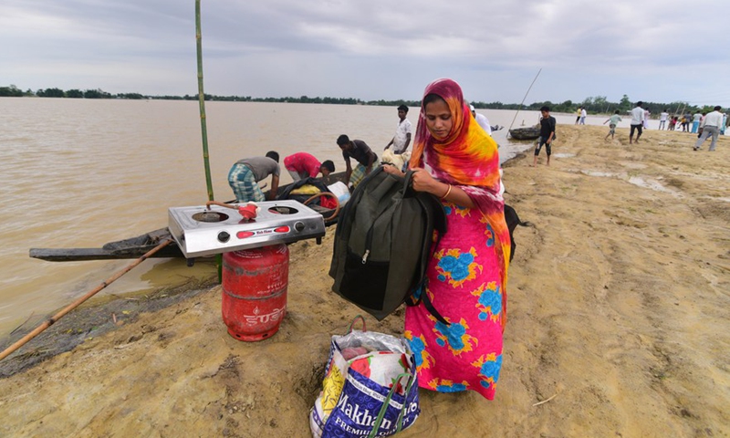 Flood-affected villagers arrive at a safer place by boat in Hojai district of India's northeastern state of Assam, June 18, 2022.Photo:Xinhua