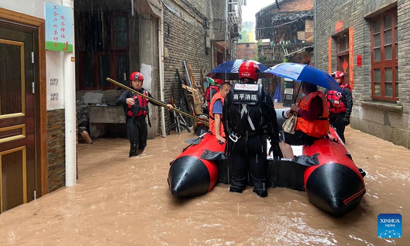 Rescuers evacuate stranded people in flood water in Songxi County of Nanping, southeast China's Fujian Province, June 18, 2022.Photo:Xinhua