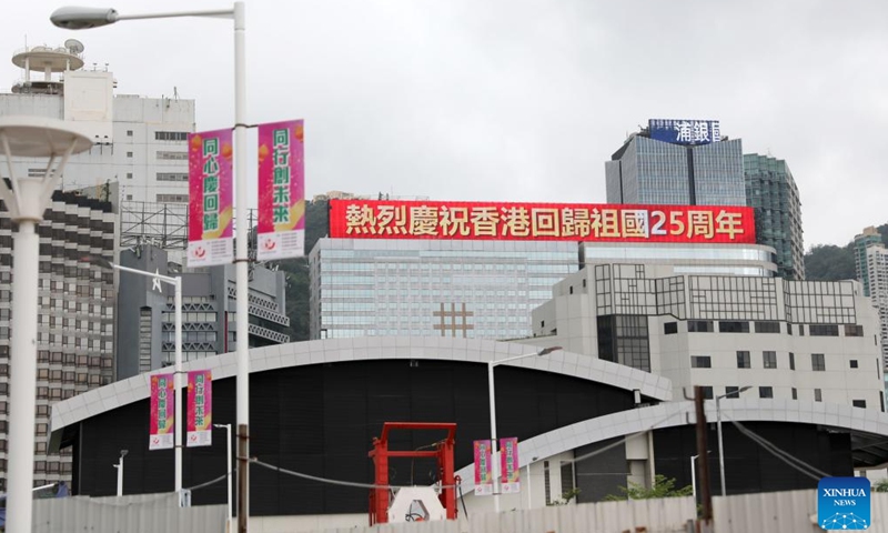 A slogan celebrating the 25th anniversary of Hong Kong's return to the motherland is displayed on an electronic screen of a building in Hong Kong, south China, June 19, 2022.Photo:Xinhua