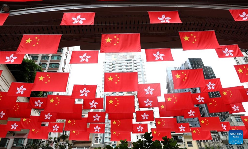 China's national flags and the Hong Kong Special Administrative Region (HKSAR) flags are hung above a street in Hong Kong, south China, June 19, 2022.Photo:Xinhua