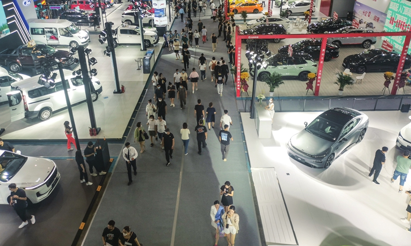 Visitors pass by a new-energy vehicle (NEV) and smart car show as it kicks off in Shenyang, capital of Northeast China’s Liaoning Province on June 21, 2022. China produced 466,000 NEVs in May, with 447,000 sold, both up 1.1 times from the year before, industry data showed. Photo: cnsphoto