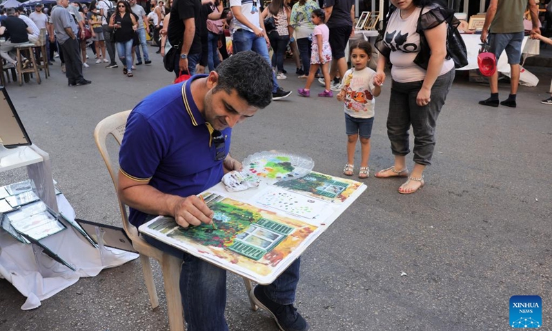 An artist paints during a street festival held in Mar Mikhael, in Beirut, Lebanon, June 19, 2022.(Photo: Xinhua)