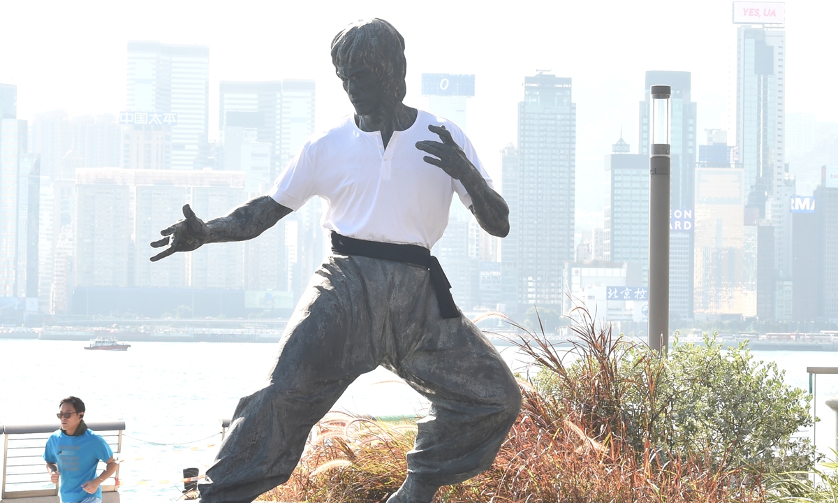 Poster for upcoming movie <em>Integrity</em> starring Simon Yam (left) and Aaron Kwok A statue of Bruce Lee in Hong Kong Photos: IC