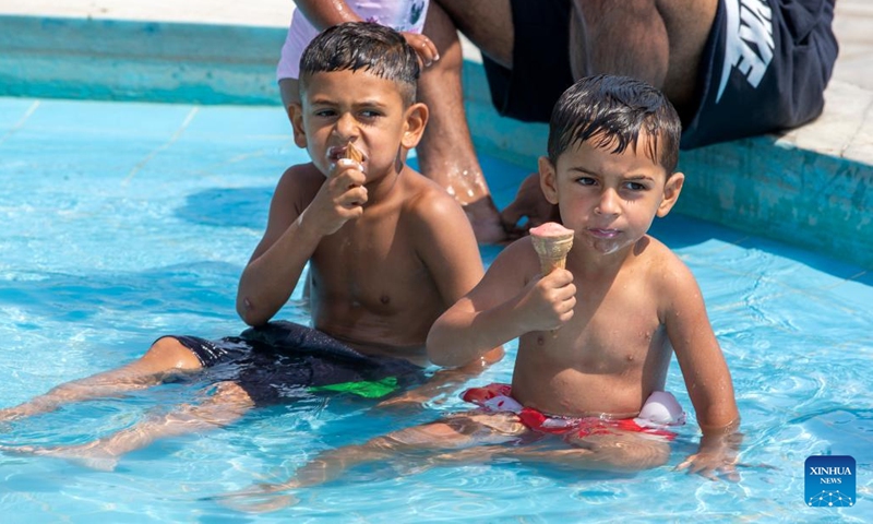 Children have ice creams in a fountain during a heatwave in Athens, Greece, on June 22, 2022.(Photo: Xinhua)