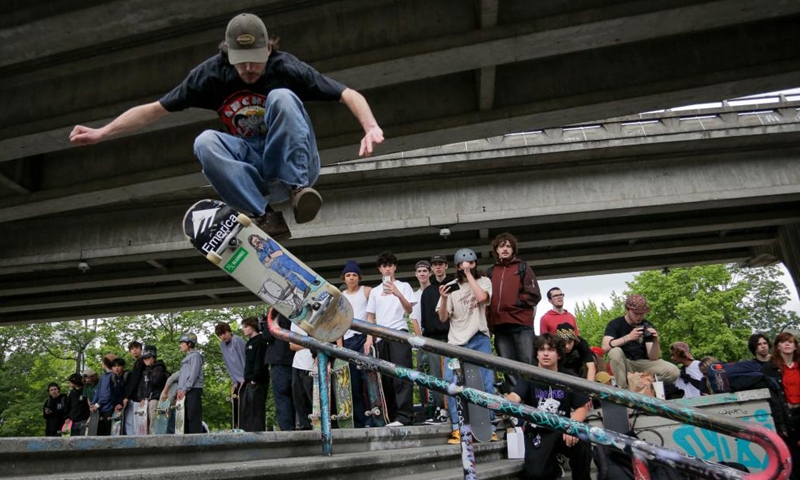 A man performs a trick during the Go Skateboarding Day event in Vancouver, British Columbia, Canada, on June 21, 2022. Skateboarders rolled down the streets of Vancouver in celebration of the annual Go Skateboarding Day which is observed on June 21.(Photo: Xinhua)