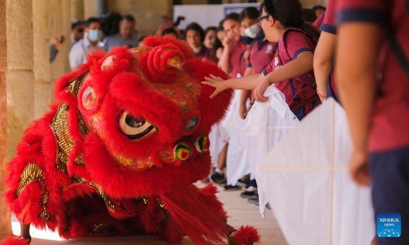Students watch a lion dance performance in Kalkara, Malta, on June 22, 2022. The Esplora Interactive Science Center in Malta was bustling with activities on Wednesday as students from primary schools got a break from the classroom to attend the 4th edition of the Chinese kite festival.(Photo: Xinhua)