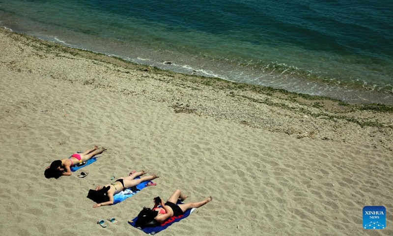 People spend their time on a beach in Costinesti, Romania, on June 21, 2022.(Photo: Xinhua)