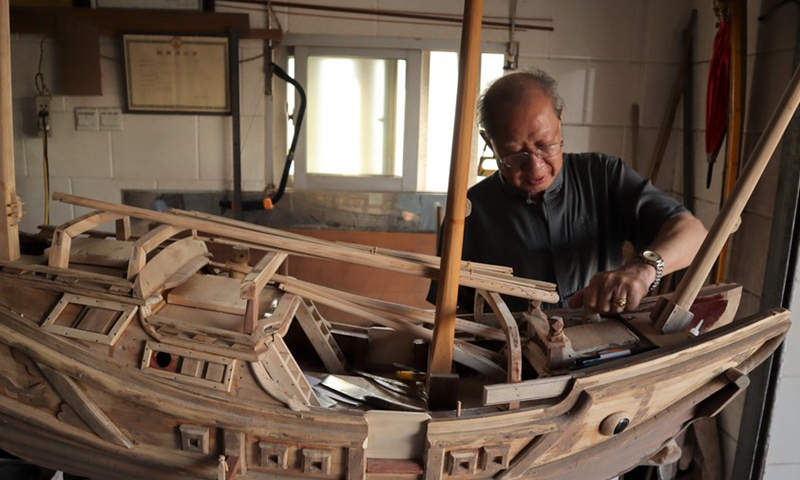 Zhang Guohui, an inheritor of the watertight-bulkhead technology of Chinese junks, makes a model boat at a workshop in Chongwu Town, Hui'an County of Quanzhou, east China's Fujian Province, April 29, 2022.(Photo: Xinhua)